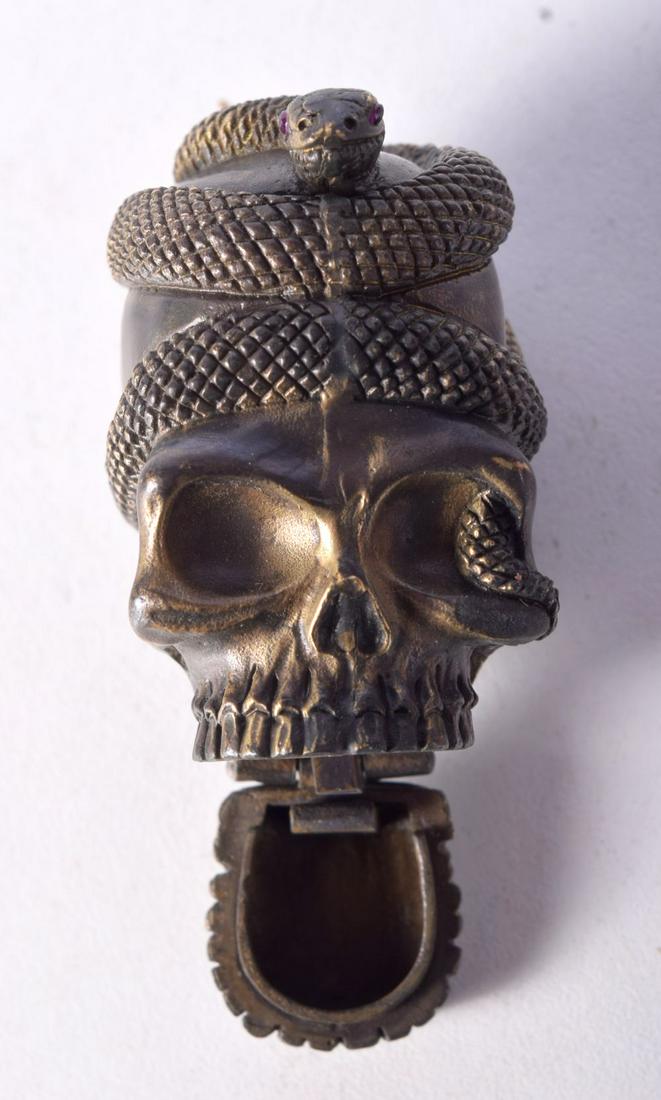 A BRASS VESTA CASE IN THE FORM OF A SKULL  WITH A SNAKE WRAPPED AROUND THE TOP.  5.1cm x 3.7cm, weig (1 of 3)