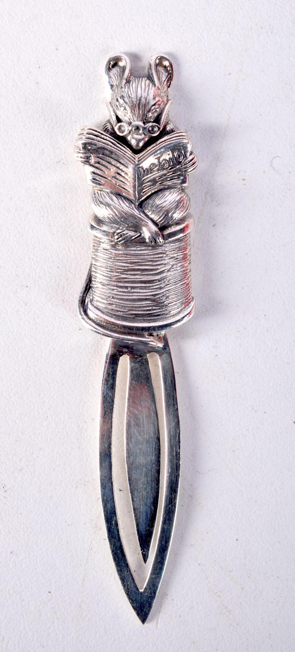 A SILVER BOOKMARK DECORATED WITH A MOUSE READING A BOOK.  Stamped Sterling, 7.4cm x 1.6cm, weight 8. (1 of 2)
