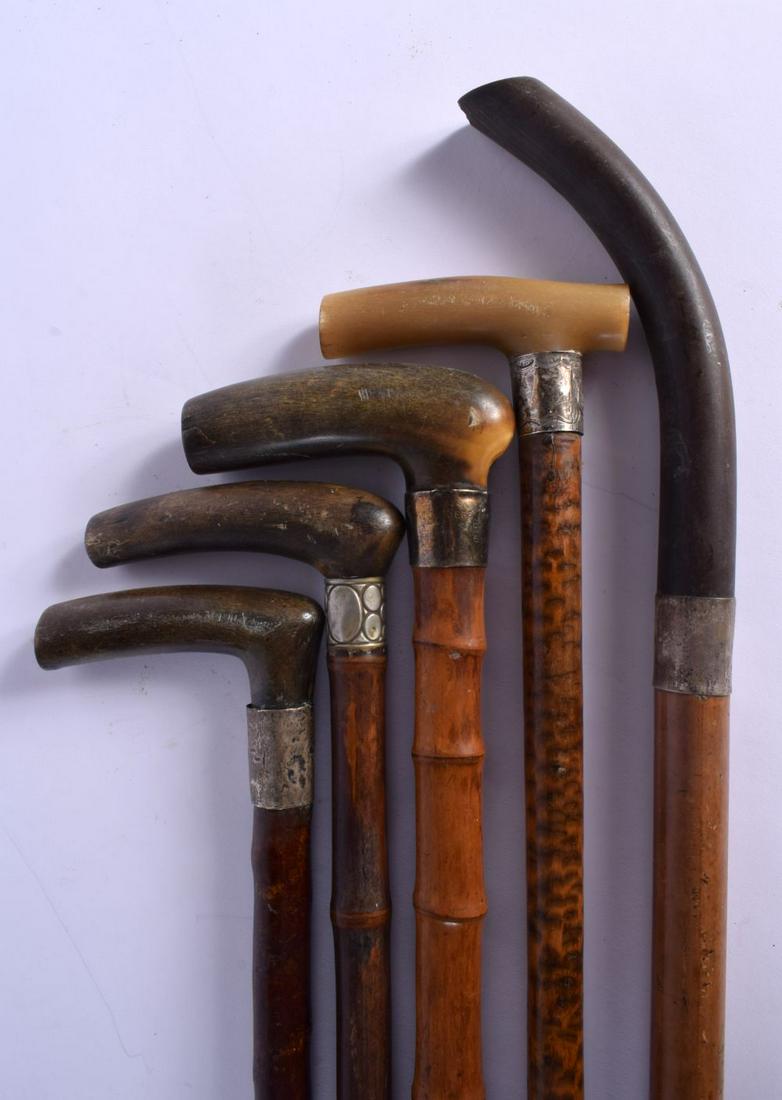 FIVE 19TH CENTURY MIDDLE EASTERN CARVED RHINOCEROS HORN WALKING CANES some with silver mounts. 90 cm (1 of 3)