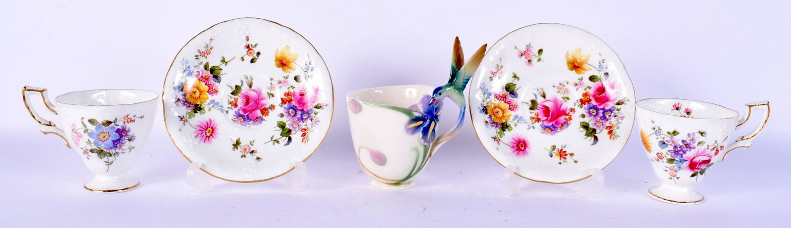 A PAIR OF ROYAL CROWN DERBY CUPS AND SAUCERS together with a Franz cup. (5): A PAIR OF ROYAL CROWN DERBY CUPS AND SAUCERS together with a Franz cup. (5)
