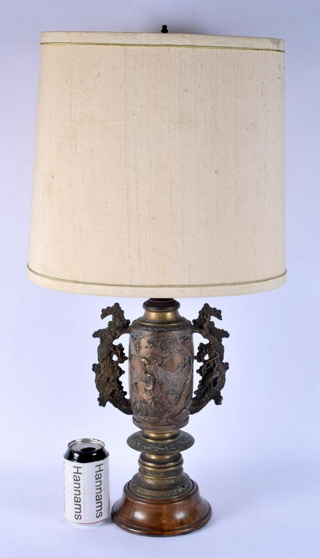 A LARGE 19TH CENTURY JAPANESE MEIJI PERIOD TWIN HANDLED BRONZE VASE decorated with buddhistic figure (1 of 3)