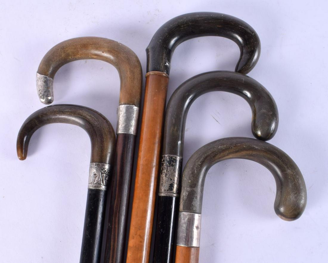 FIVE 19TH CENTURY MIDDLE EASTERN CARVED RHINOCEROS HORN HANDLED WALKING CANES. 90 cm long. (5) (1 of 3)