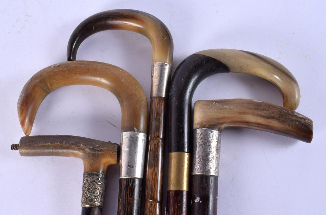 FIVE 19TH CENTURY MIDDLE EASTERN CARVED RHINOCEROS HORN HANDLED WALKING CANES. 90 cm long. (5) (1 of 3)