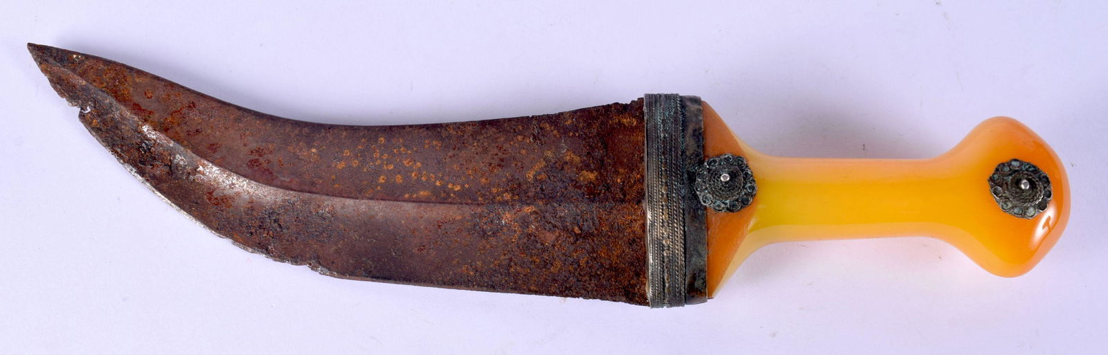 A 19TH CENTURY MIDDLE EASTERN OMANI CARVED AMBER HANDLED JAMBIYA DAGGER with white metal mounts. 32 (1 of 4)