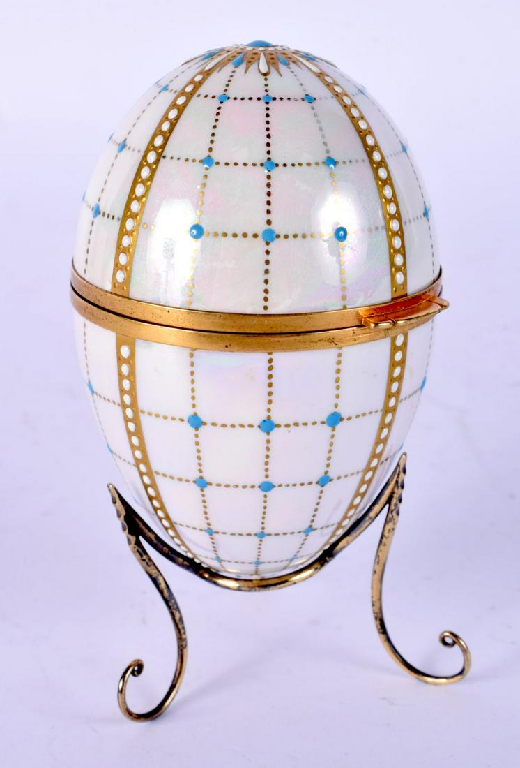 A FINE ENGLISH SILVER GILT AND ENAMELLED PORCELAIN EGG with internally painted landscapes 11 cm high (1 of 7)