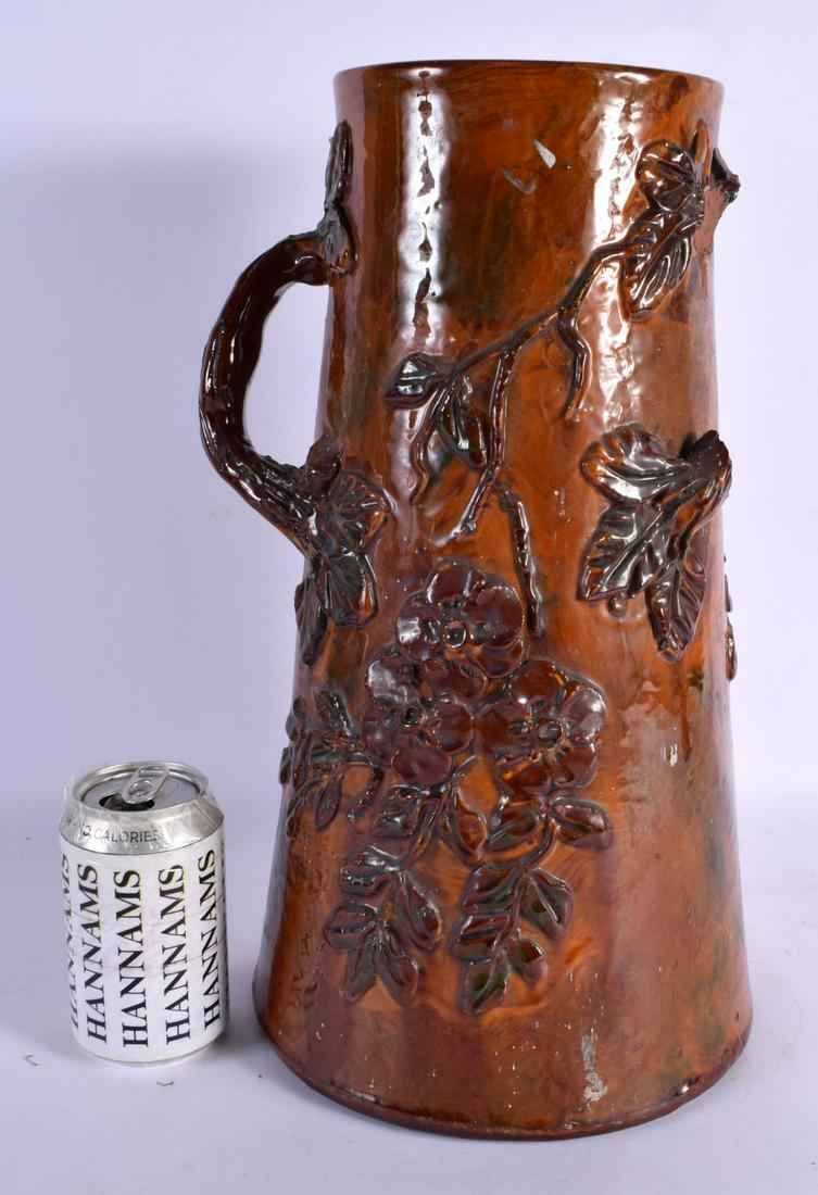 A LARGE EARLY TORQUAY WARE POTTERY JUG overlaid with leaves. 43 cm high. (1 of 5)