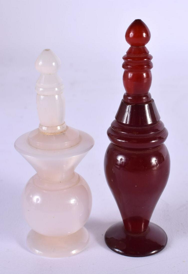 A VINTAGE CHERRY AMBER TYPE BOTTLE AND COVER together with another. Largest 10 cm high. (2): A VINTAGE CHERRY AMBER TYPE BOTTLE AND COVER together with another. Largest 10 cm high. (2)