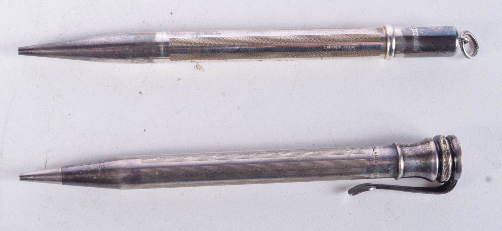 2 SILVER PROPELLING PENCILS (1 SILVER PLATE, 1 HALLMARKED LONDON 1948).  Longest 10.6cm (2) (1 of 2)