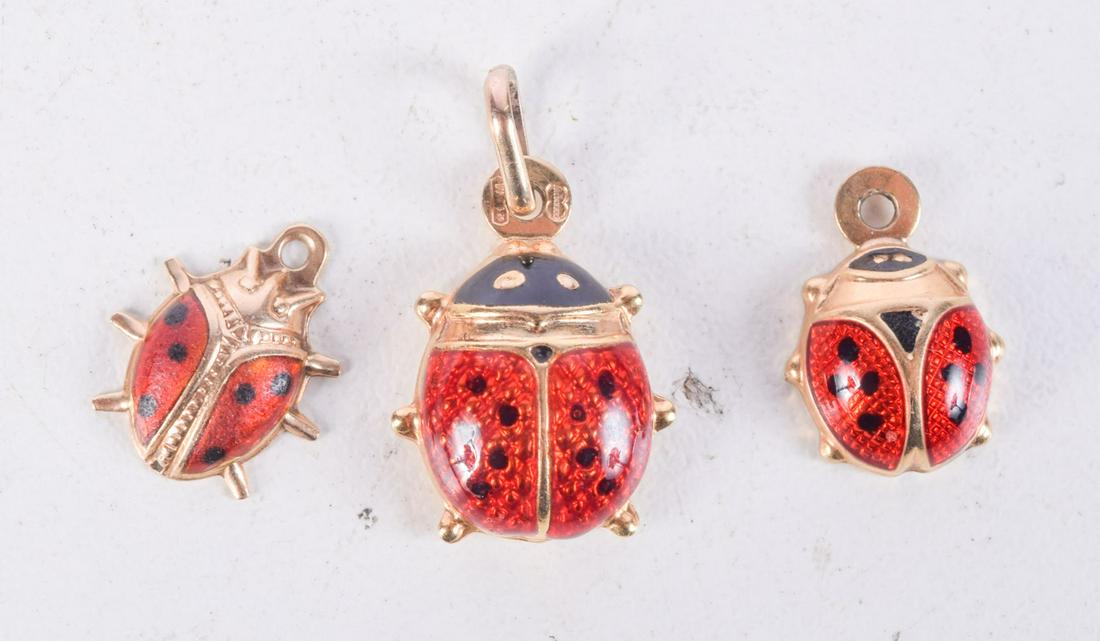 THREE 9CT GOLD AND ENAMEL PENDANTS.  Largest 1.7cm x 1.2cm, total weight 2.2g (1 of 2)