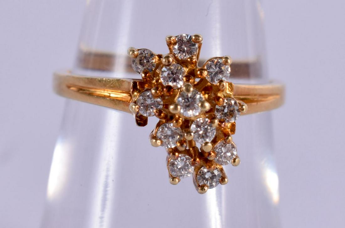 A 14CT GOLD AND DIAMOND CLUSTER RING. 3.2 grams. L/M. (1 of 2)