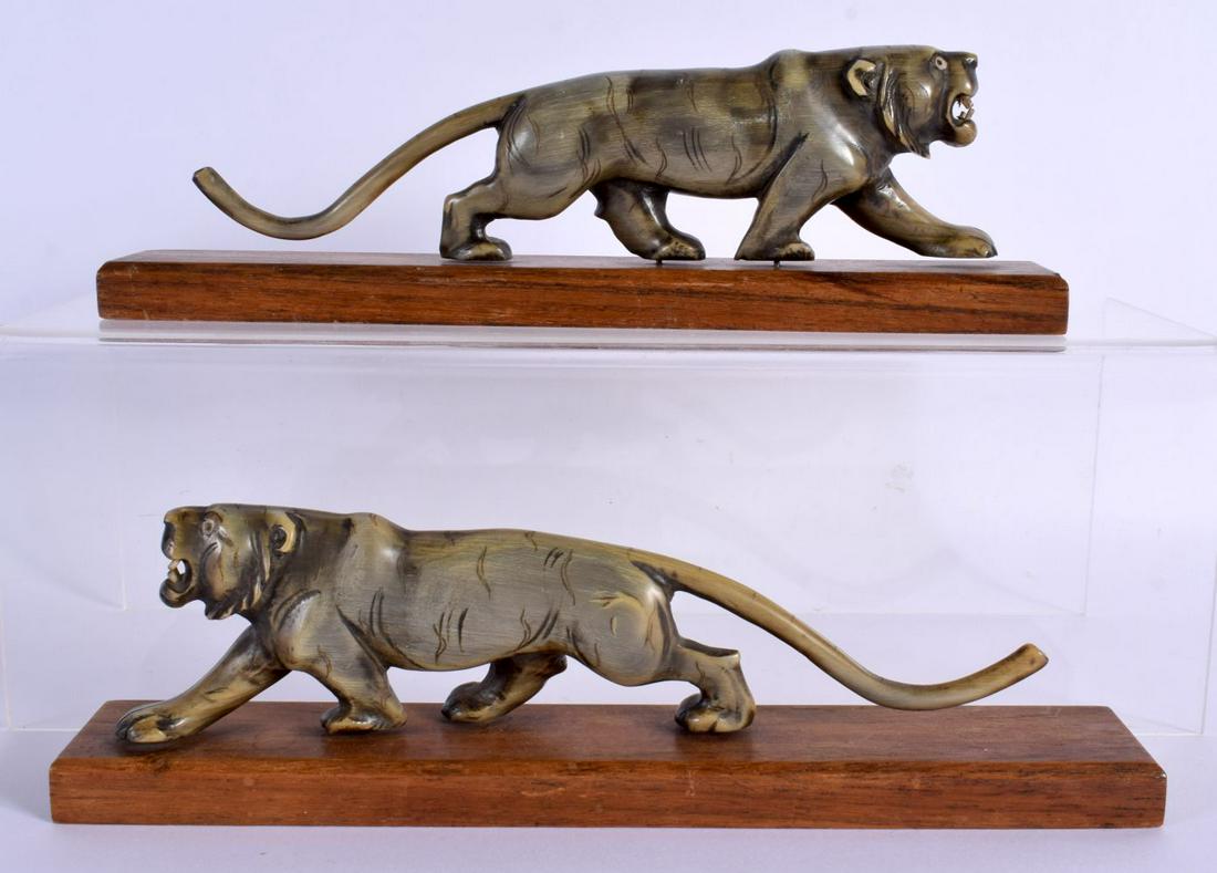 A PAIR OF 19TH CENTURY CARVED MIDDLE EASTERN RHINOCEROS HORN TIGERS modelled roaming upon wood bases (1 of 4)