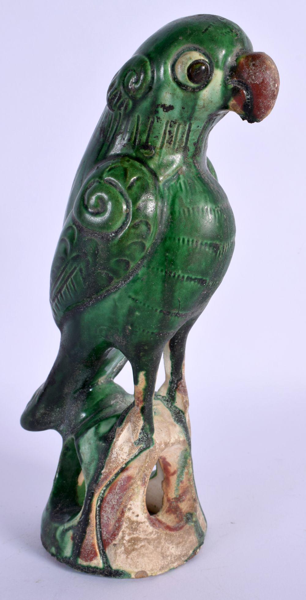 A CHINESE QING DYNASTY GREEN GLAZE FIGURE OF A PARROT modelled upon a naturalistic base. 21 cm high.: A CHINESE QING DYNASTY GREEN GLAZE FIGURE OF A PARROT modelled upon a naturalistic base. 21 cm high.