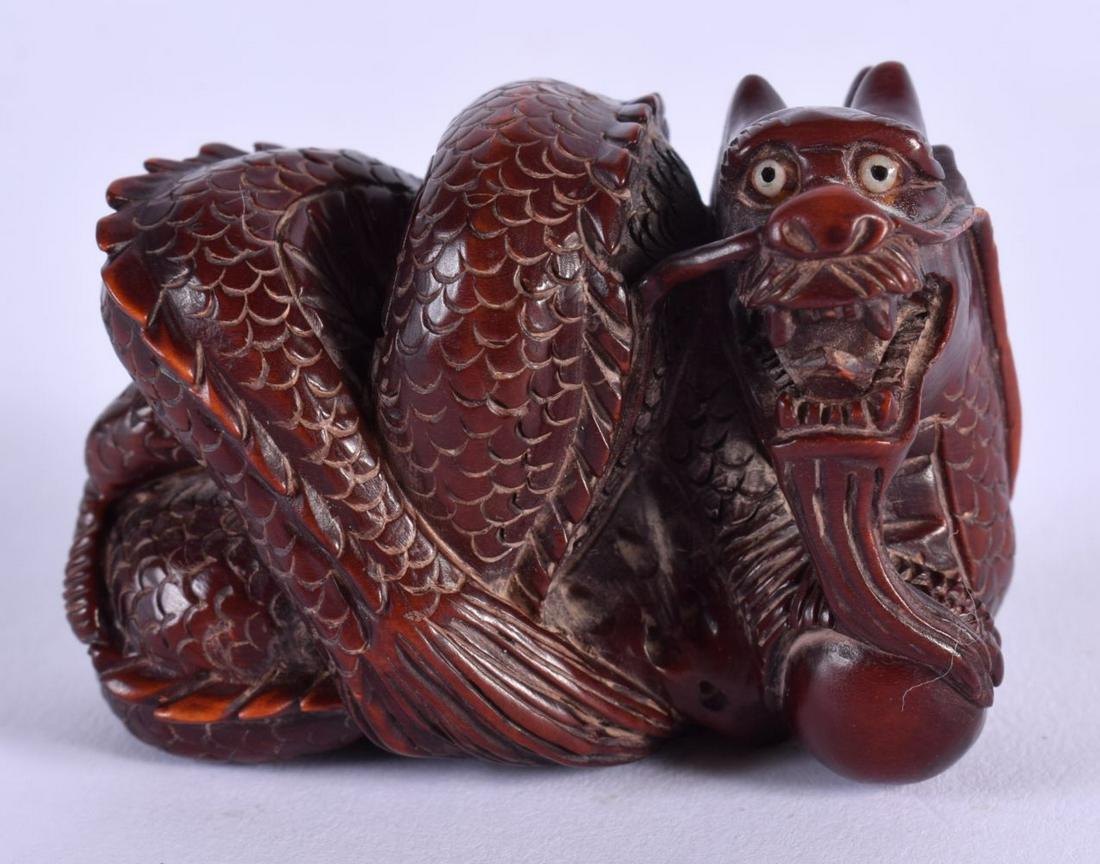 A JAPANESE BOXWOOD DRAGON NETSUKE. 4 cm x 3 cm. (1 of 4)