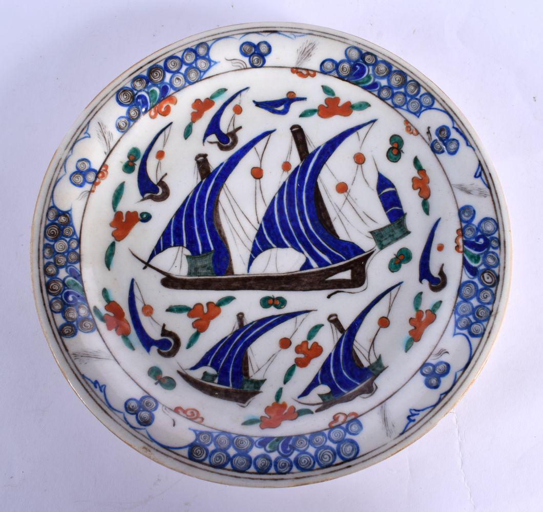 A TURKISH MIDDLE EASTERN FAIENCE DISH painted with boats. 27 cm diameter. (1 of 2)