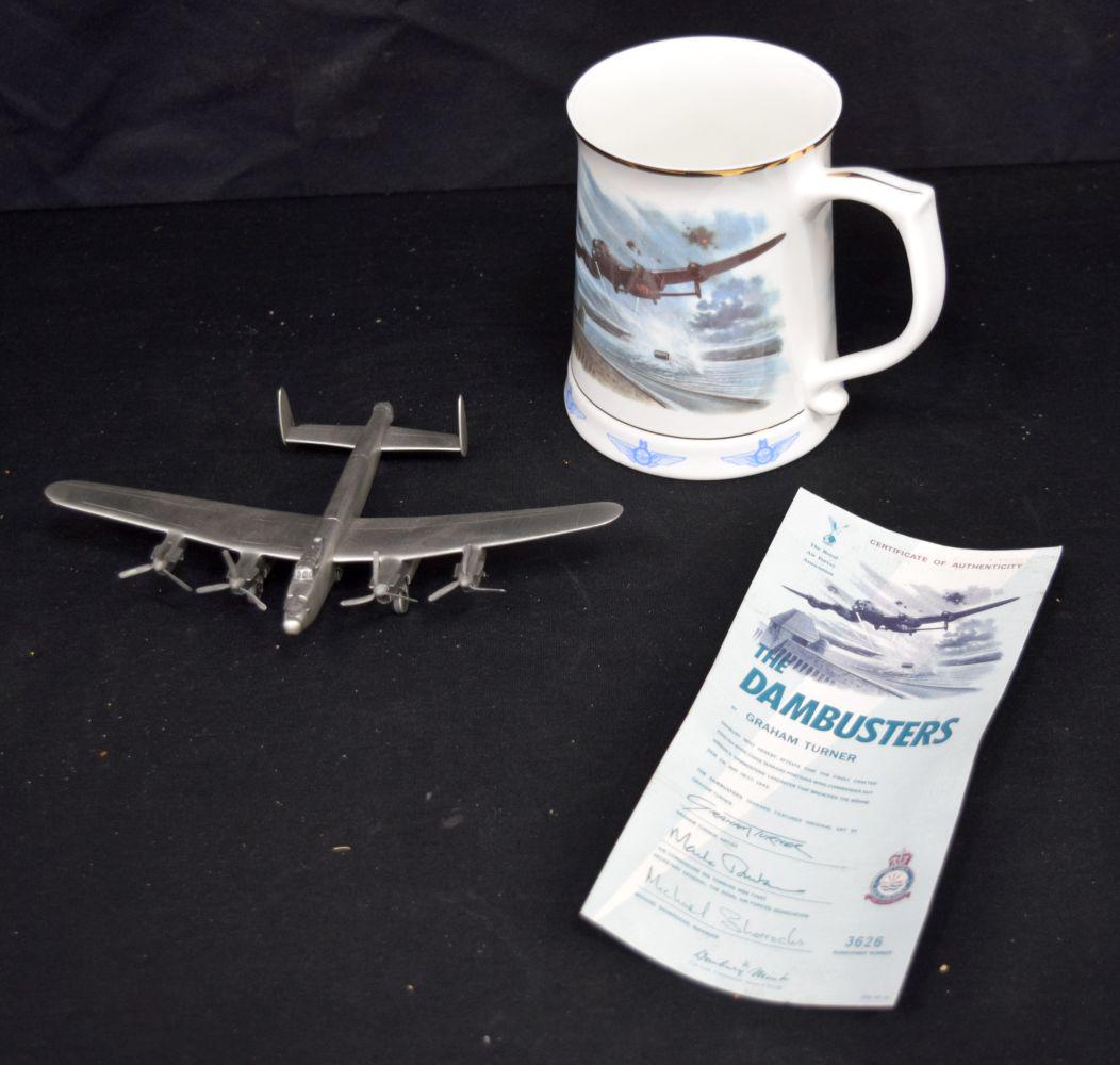 A Dam Busters porcelain tankard together with a Pewter model of a Dam busters plane largest 21 cm (2: A Dam Busters porcelain tankard together with a Pewter model of a Dam busters plane largest 21 cm (2)