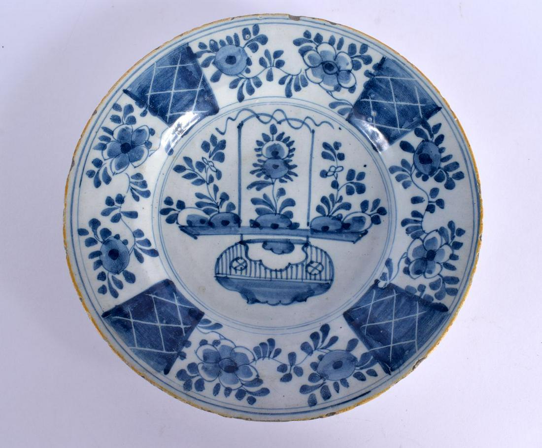 AN 18TH CENTURY DELFT BLUE AND WHITE TIN GLAZED PLATE painted with a basket of flowers. 22 cm wide. (1 of 2)