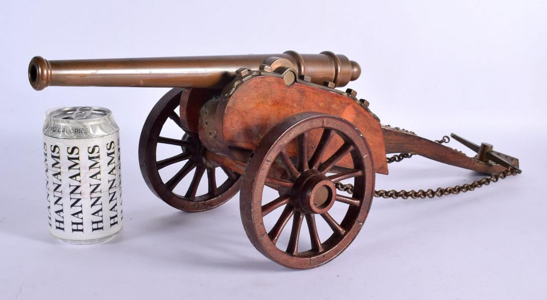 AN ANTIQUE BRONZE CANNON upon a wooden support. 55 cm x 24 cm. (1 of 3)