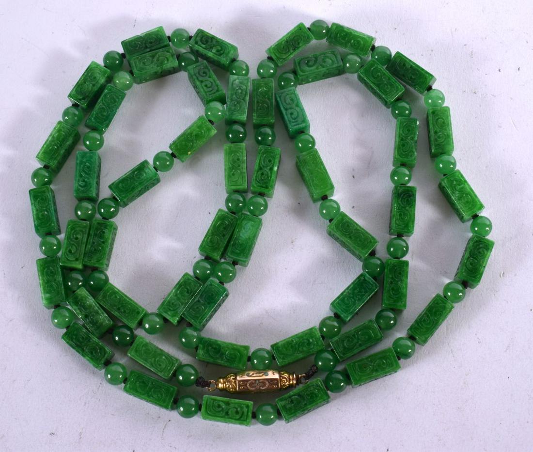 A GREEN JADE NECKLACE WITH YELLOW METAL MOUNTS.  116cm long  Oblong Beads 14.6mm x 6.7mm  weight 127 (1 of 2)