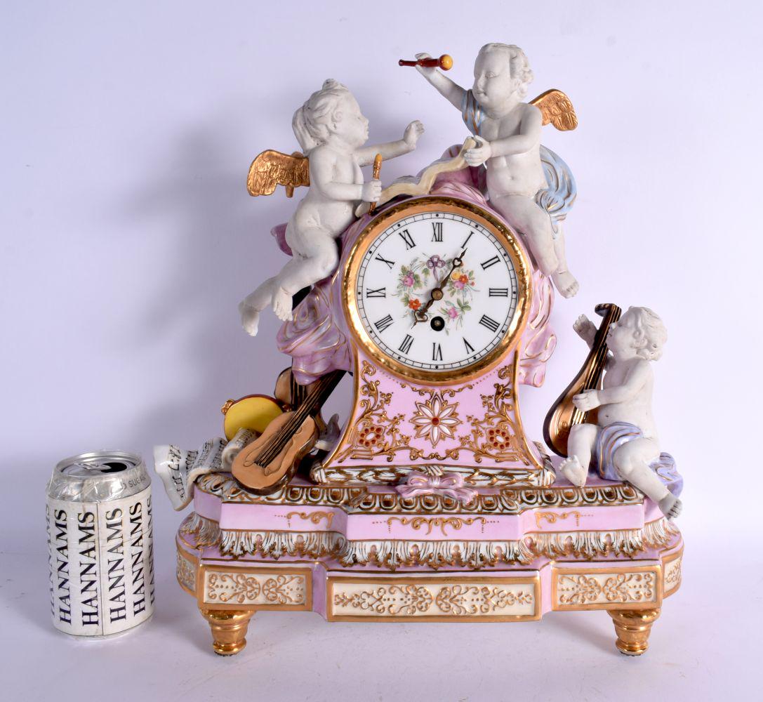 A LARGE CONTINENTAL PINK AND BISQUE PORCELAIN MANTEL CLOCK embellished with flowers and vines. 42 cm (1 of 7)