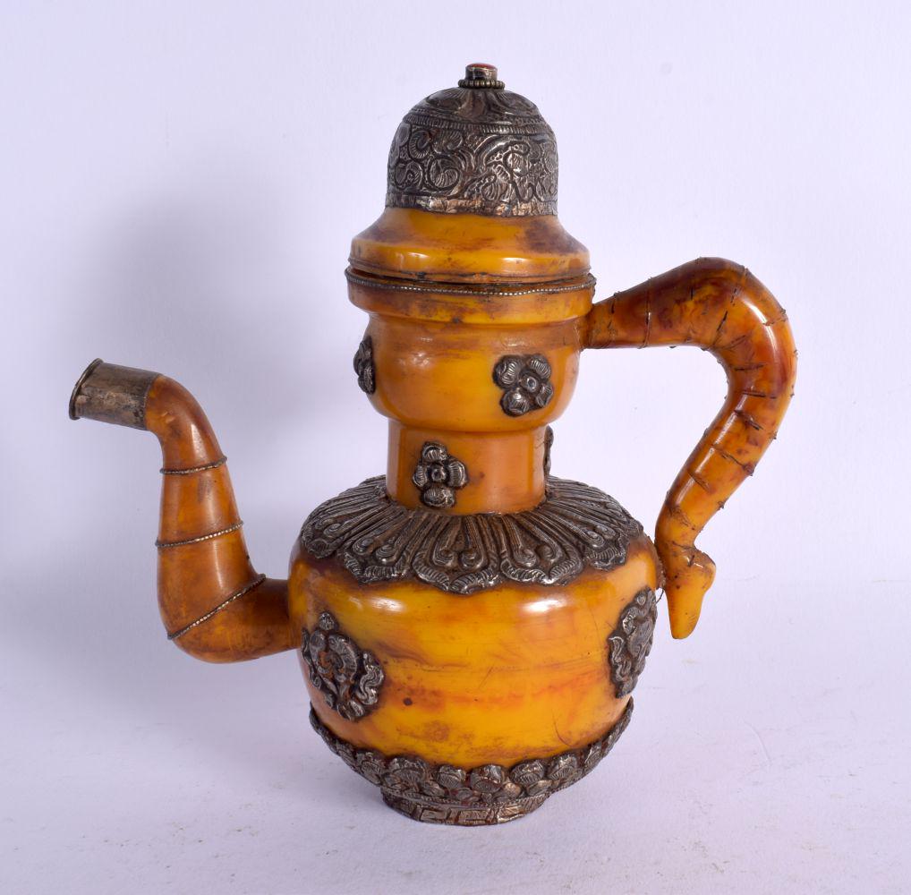AN EARLY 20TH CENTURY SINO TIBETAN AMBER AND WHITE METAL EWER with coral stopper. 18 cm x 13 cm.: AN EARLY 20TH CENTURY SINO TIBETAN AMBER AND WHITE METAL EWER with coral stopper. 18 cm x 13 cm.