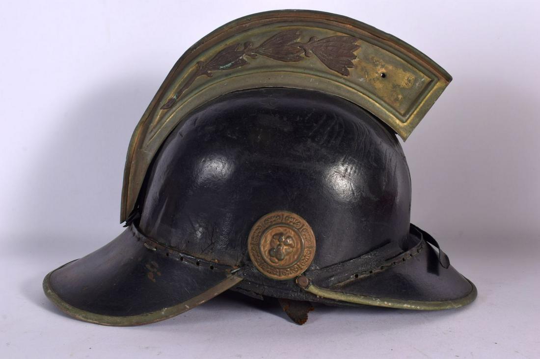 A VINTAGE FIREMANS HELMET. 27 cm x 22 cm. (1 of 5)