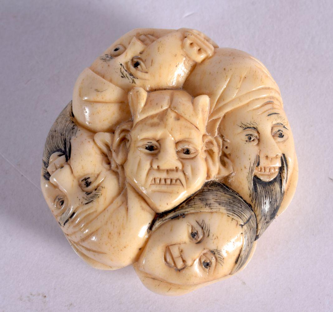 A JAPANESE CARVED BONE MASK HEAD NETSUKE. 3.75 cm wide.: A JAPANESE CARVED BONE MASK HEAD NETSUKE. 3.75 cm wide.