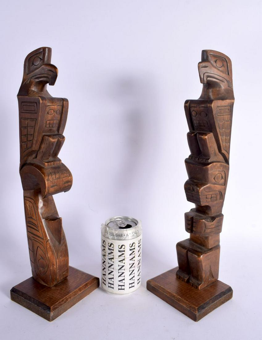 A LARGE PAIR OF NORTH AMERICAN CORMORANT ISLAND ALERT BAY HAIDA FIGURES modelled upon a rectangular: A LARGE PAIR OF NORTH AMERICAN CORMORANT ISLAND ALERT BAY HAIDA FIGURES modelled upon a rectangular base. 39 cm high.