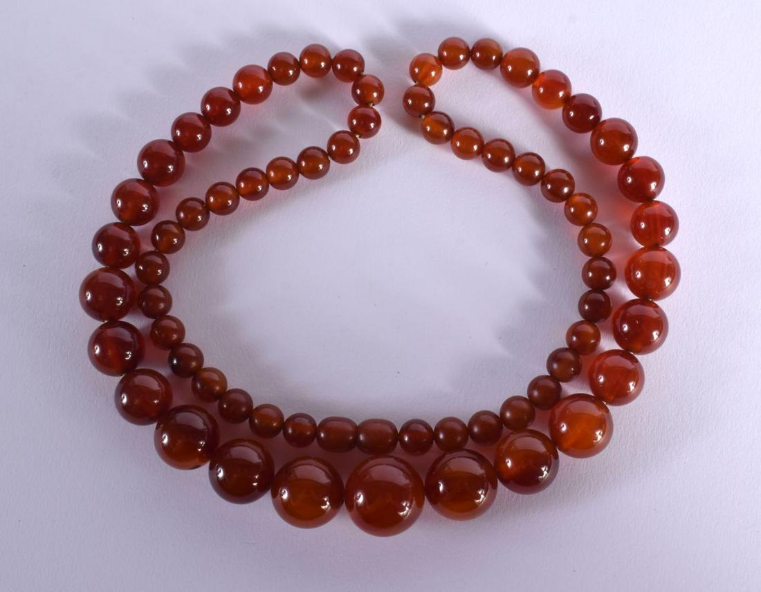 A GRADUATED AMBER COLOURED BEAD NECKLACE.  Length 74cm, weight 87g (1 of 2)