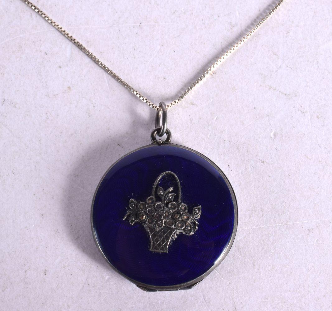 A BLUE ENAMEL PENDANT ONLAID WITH A SILVER BASKET OF FLOWERS ON A CHAIN. Pendant 3cm diameter. Chai: A BLUE ENAMEL PENDANT ONLAID WITH A SILVER BASKET OF FLOWERS ON A CHAIN. Pendant 3cm diameter. Chain 46cm