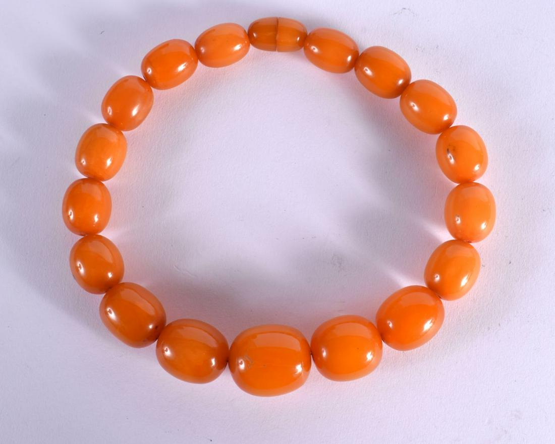 A LARGE ART DECO ORANGE AMBER TYPE BEAD NECKLACE. 140 grams. 50 cm long, largest bead 3 cm x 2.75 cm (1 of 3)