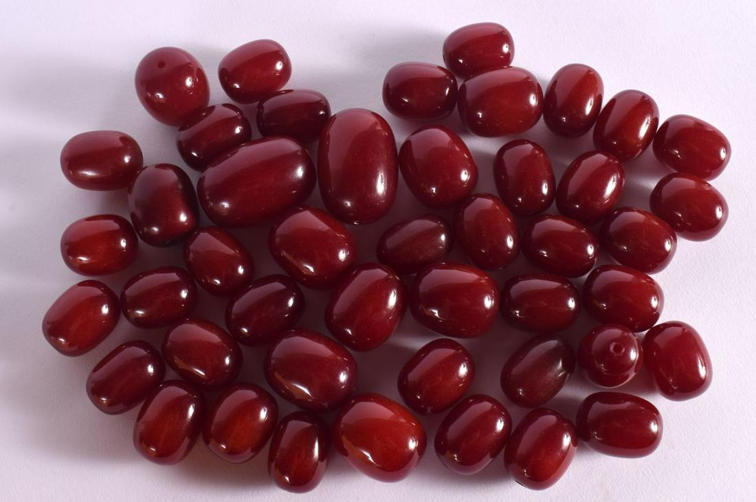 A COLLECTION OF EARLY 20TH CENTURY CARVED RED BAKELITE CHERRY AMBER TYPE BEADS possibly Faturan. Lar (1 of 8)