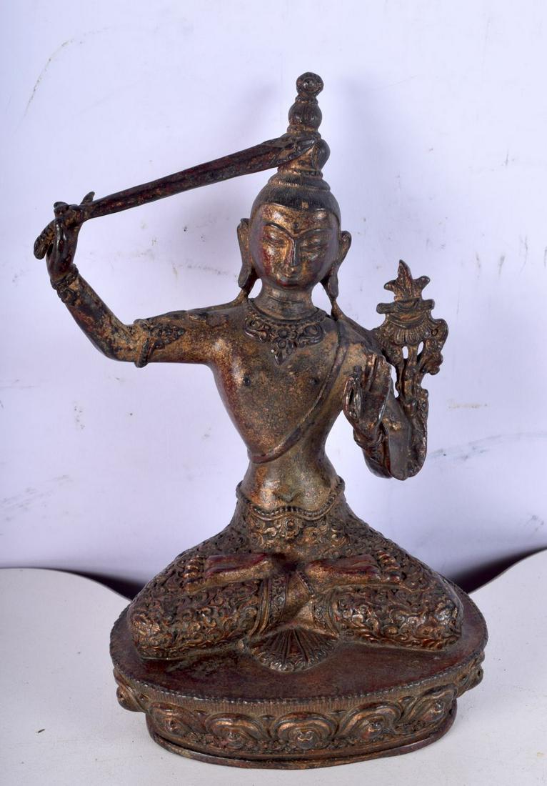 A Chinese Tibetan gilded bronze figure of a seated male brandishing a sword. 19 x 12cm. (1 of 4)