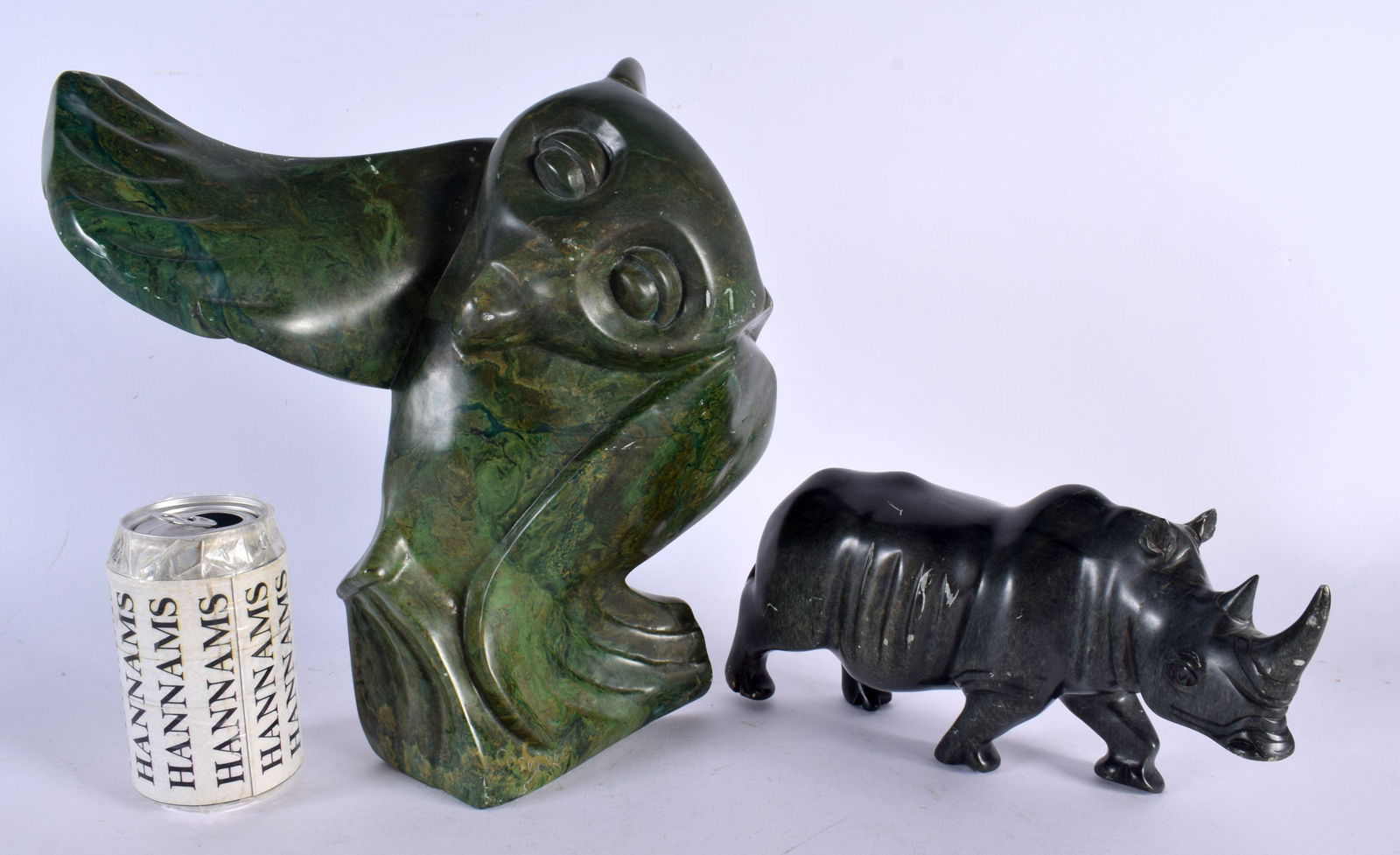 A LARGE NORTH AMERICAN INUIT CARVED STONE FIGURE OF AN OWL together with a similar carved stone figu (1 of 3)