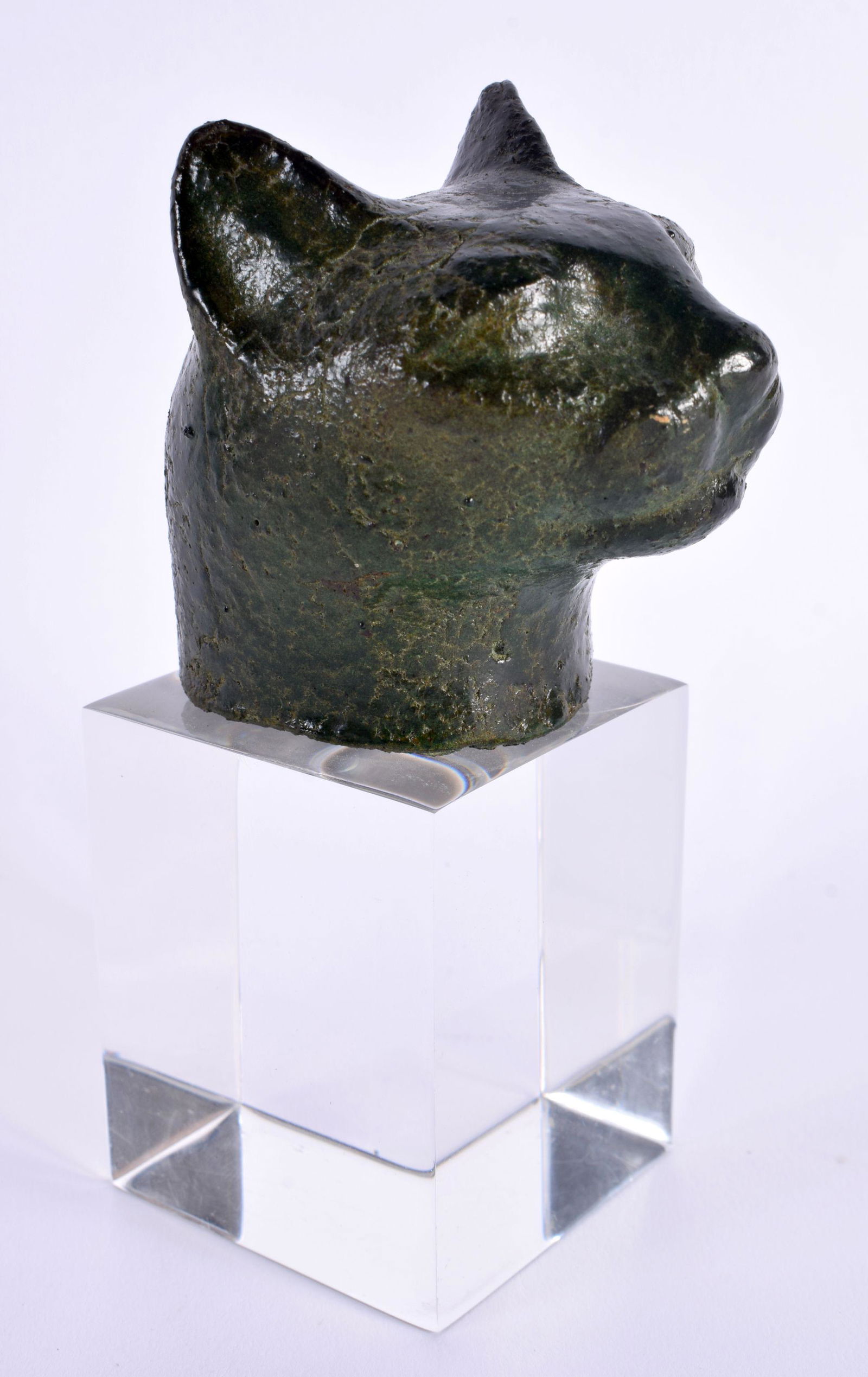 A 19TH CENTURY EGYPTIAN GRAND TOUR CARVED STONE HEAD OF A CAT After the Antiquity, upon a later pers: A 19TH CENTURY EGYPTIAN GRAND TOUR CARVED STONE HEAD OF A CAT After the Antiquity, upon a later perspex base. 13 cm high.