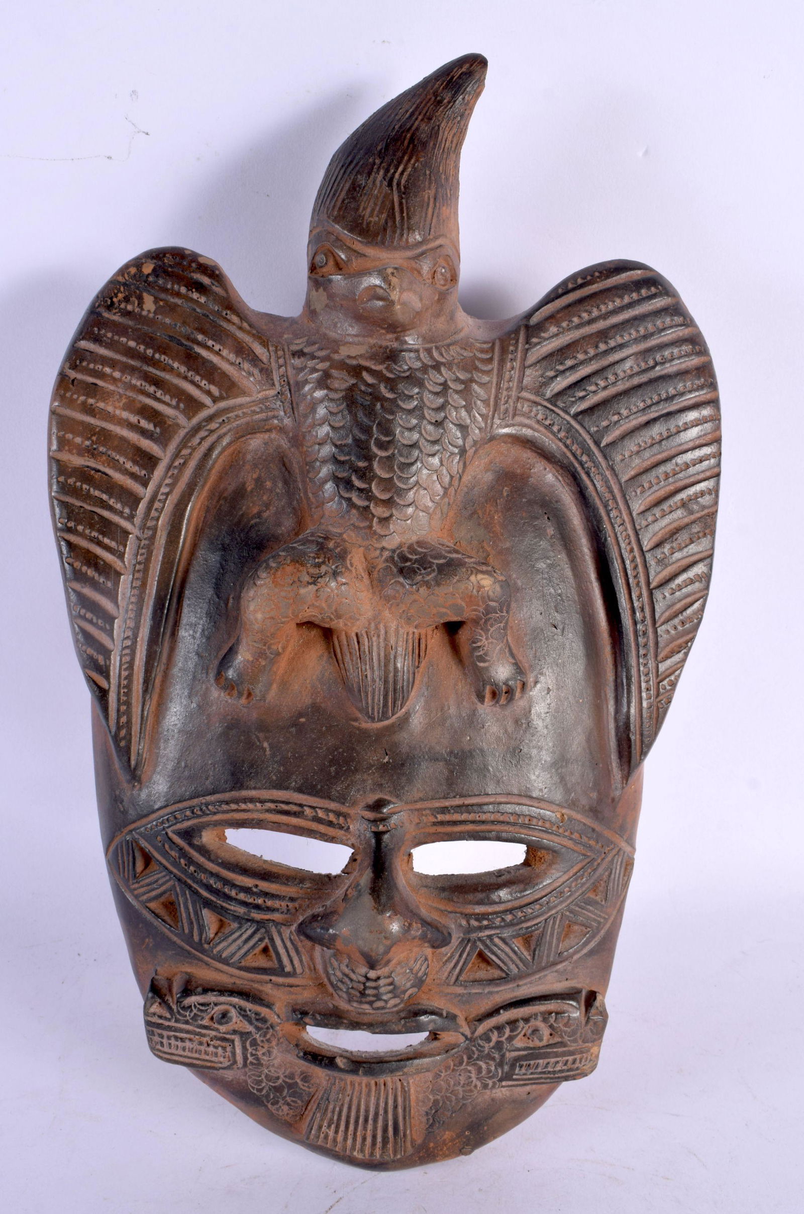 A SOUTH AMERICAN TRIBAL POTTERY MASK. 33 cm x 15 cm. (1 of 2)