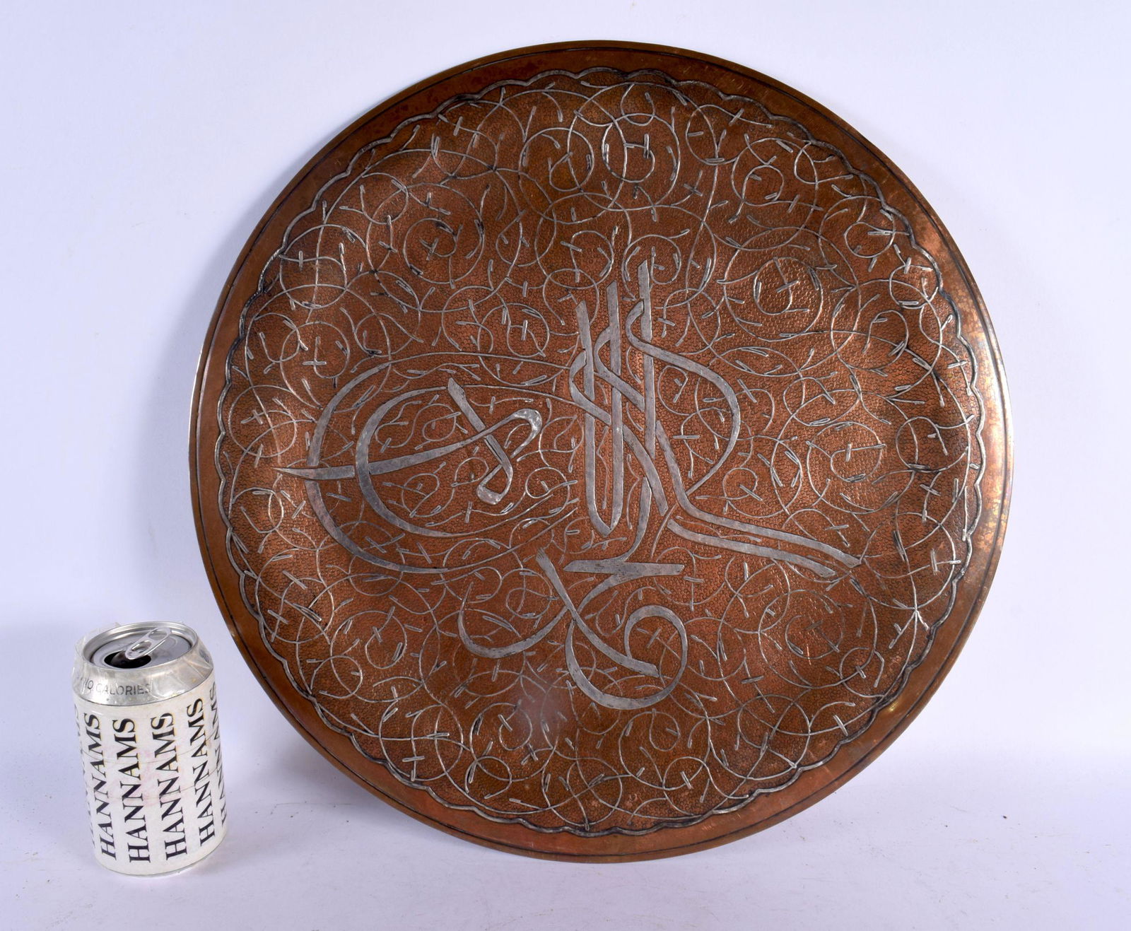 A LARGE 19TH CENTURY MIDDLE EASTERN SILVER INLAID CIRCULAR PLATE decorated with scripture and motifs (1 of 4)