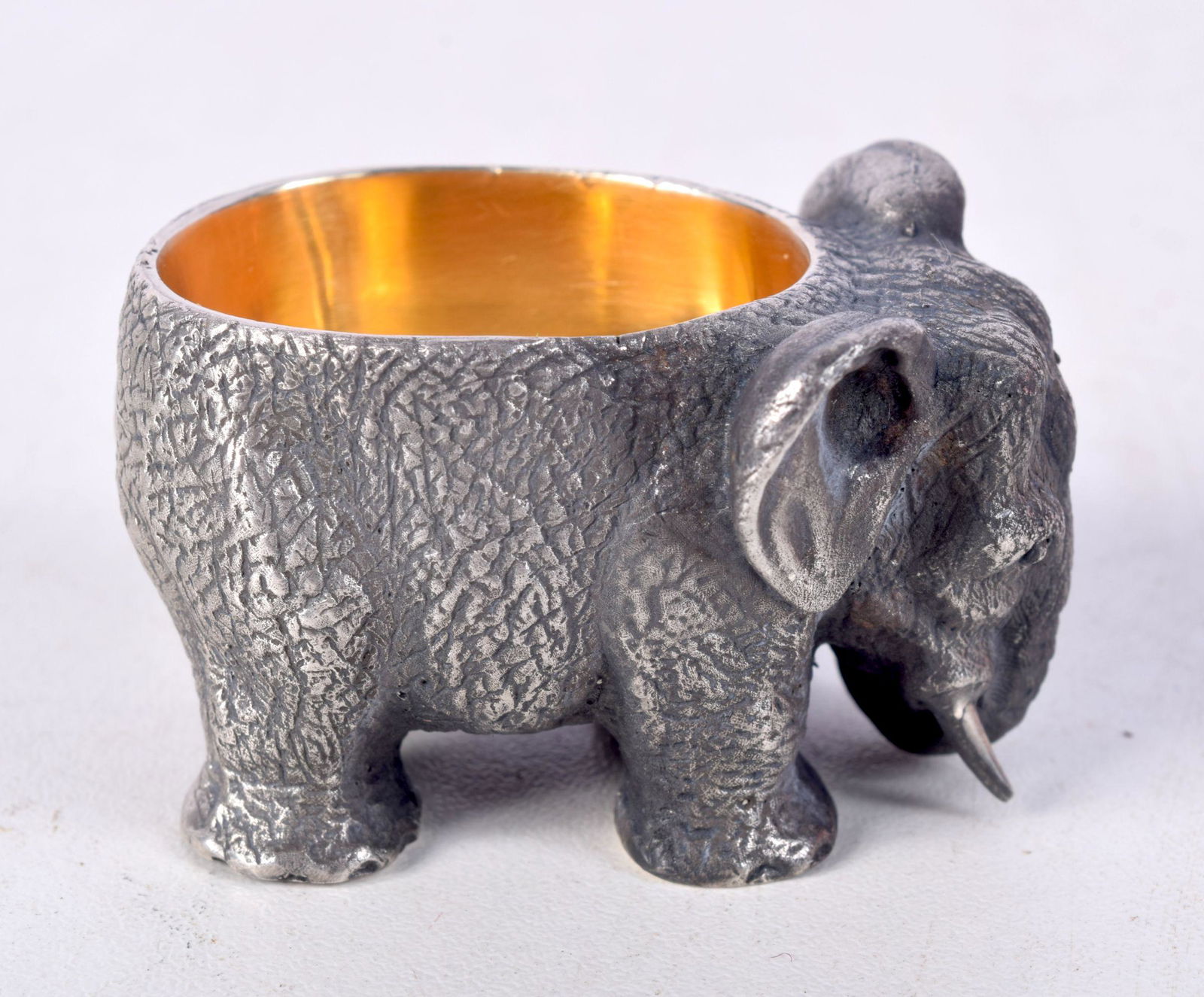 A CONTINENTAL SILVER SALT IN THE FORM OF AN ELEPHANT WITH GILT INTERIOR.  Stamped 84, 3cm x 4.8cm x (1 of 4)