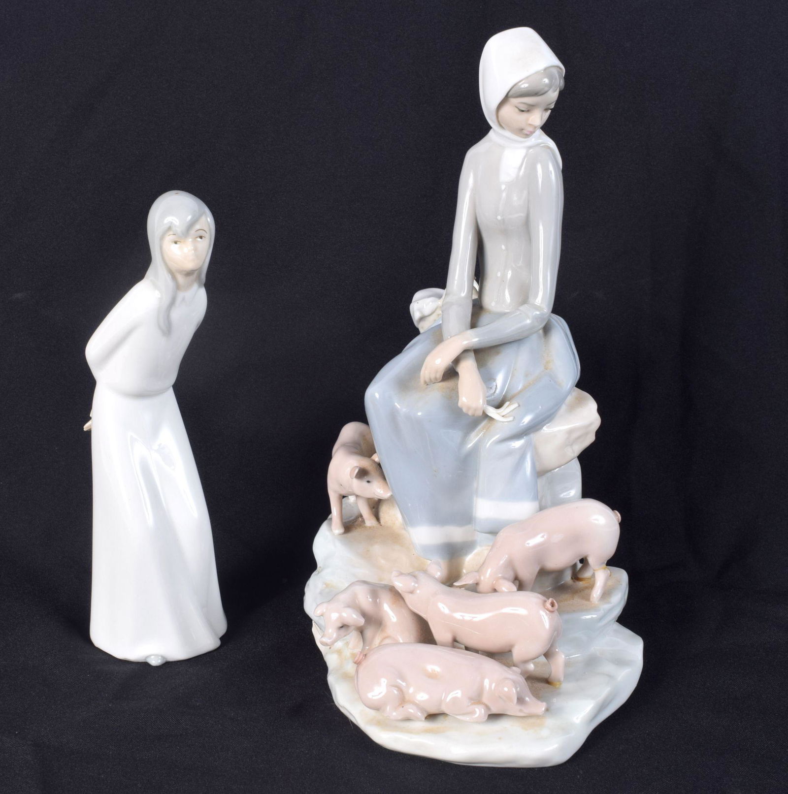 A large Lladro figure of a female with her pigs together with another figurine 28 cm (2). (1 of 5)