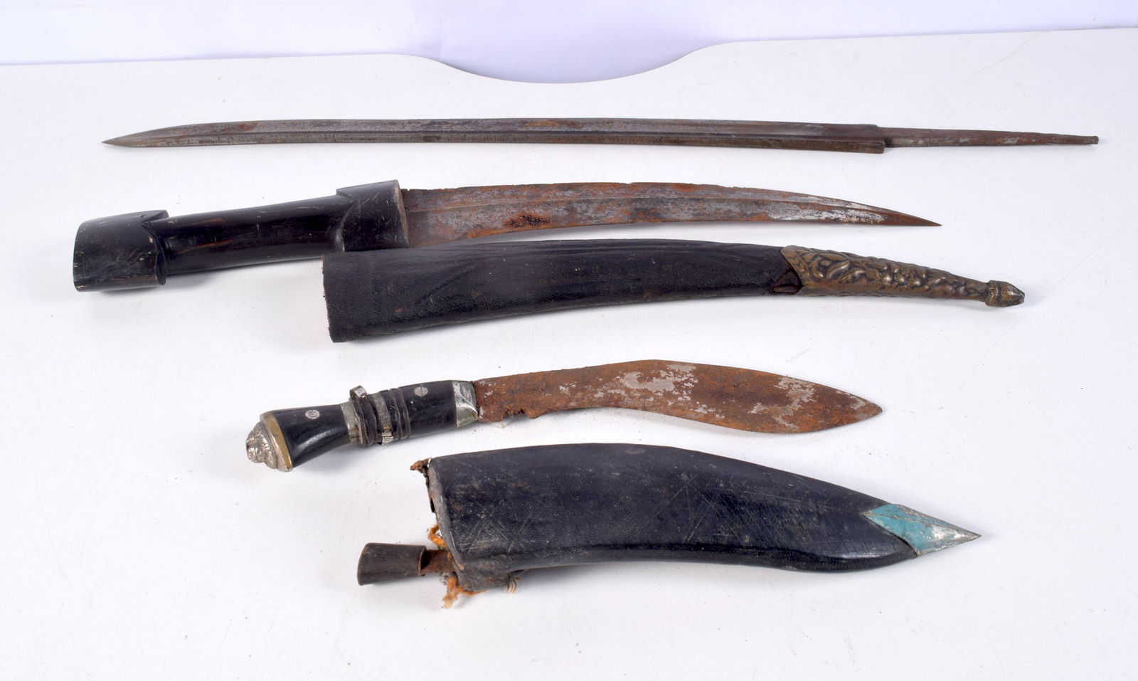 A South East Asian wooden handled dagger with leather coated wooden sheath together with a Kukri and (1 of 3)