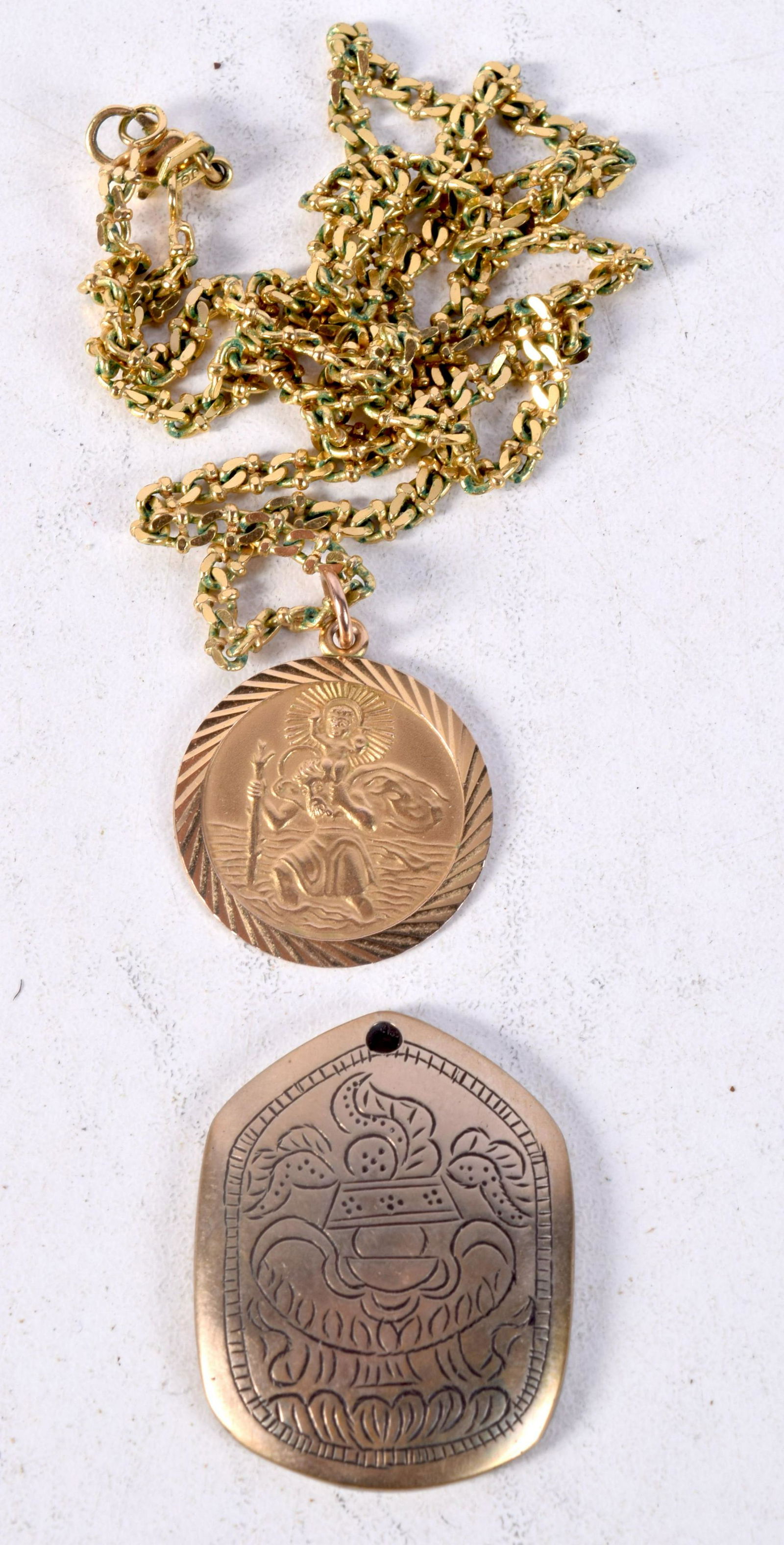 A 9 kt St Cristopher pendant on a yellow metal chain together with a white metal pendant 3.62 g (2): A 9 kt St Cristopher pendant on a yellow metal chain together with a white metal pendant 3.62 g (2)