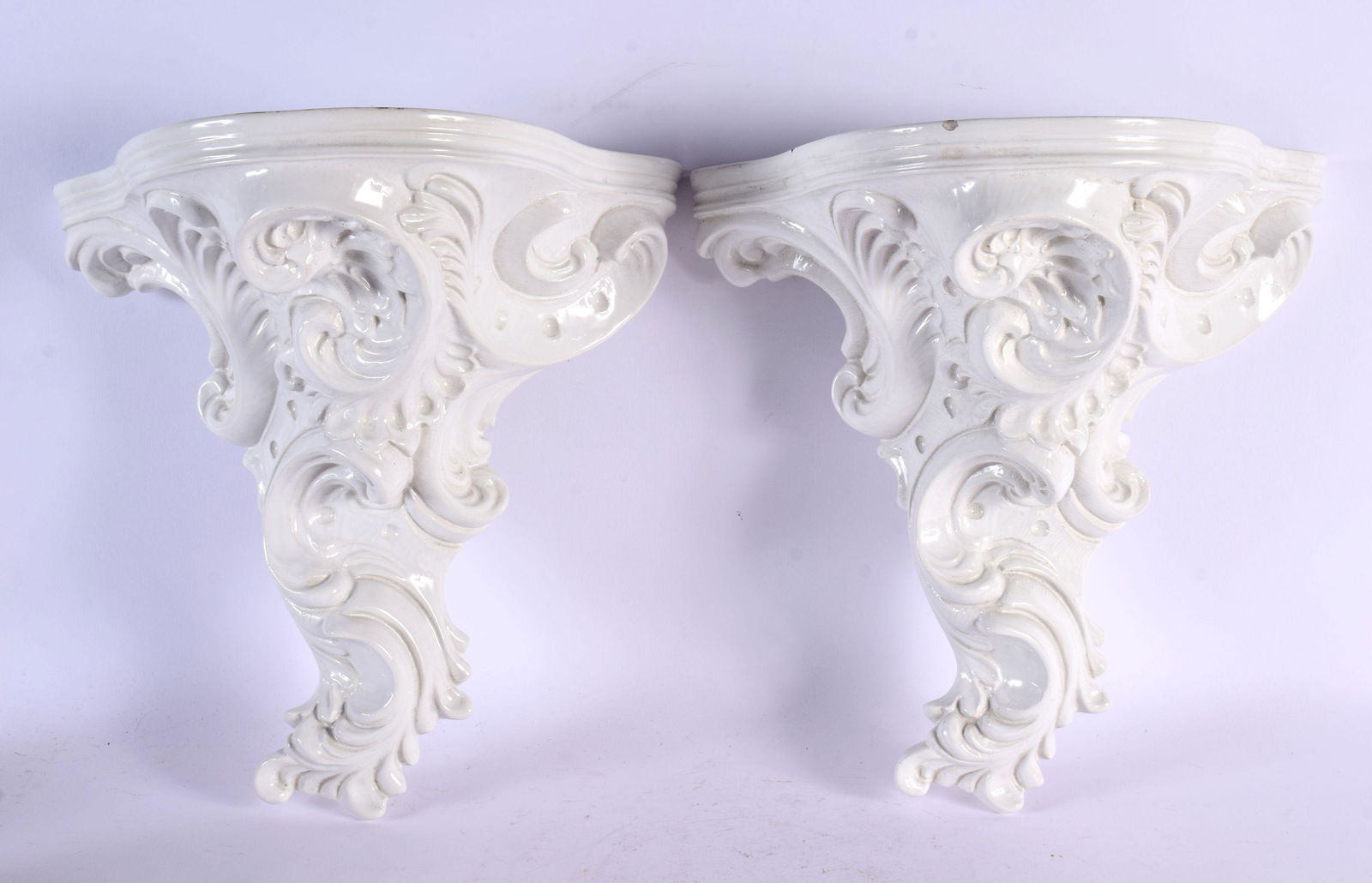 A PAIR OF VINTAGE FRENCH WHITE GLAZED POTTERY WALL BRACKETS. 32 cm x 24 cm. (1 of 2)