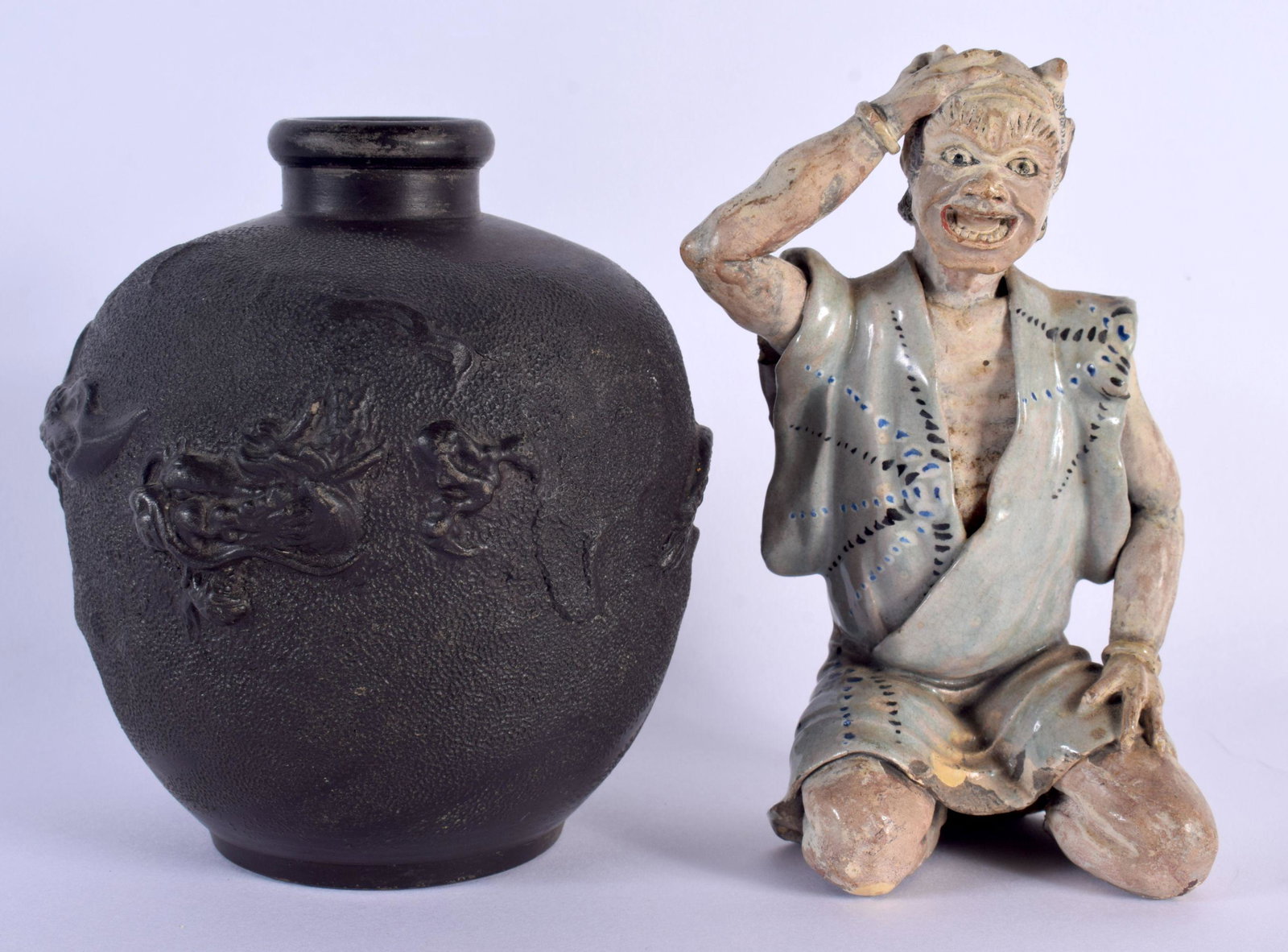A 19TH CENTURY JAPANESE MEIJI PERIOD FIGURE OF AN ONI modelled clutching his head, together with a J: A 19TH CENTURY JAPANESE MEIJI PERIOD FIGURE OF AN ONI modelled clutching his head, together with a Japanese pottery dragon vase. Largest 15 cm high. (2)