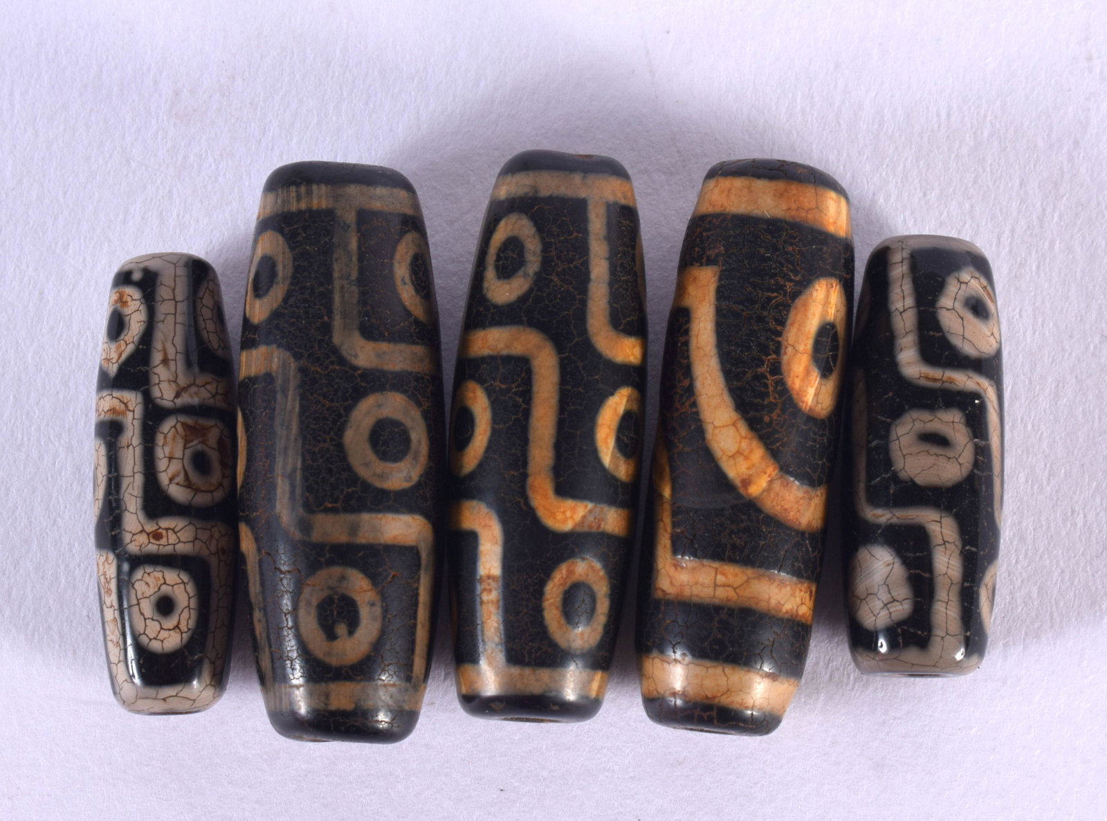 FIVE CHINESE TIBETAN AGATE ZHI BEADS 20th Century. Largest 4 cm long. (5): FIVE CHINESE TIBETAN AGATE ZHI BEADS 20th Century. Largest 4 cm long. (5)