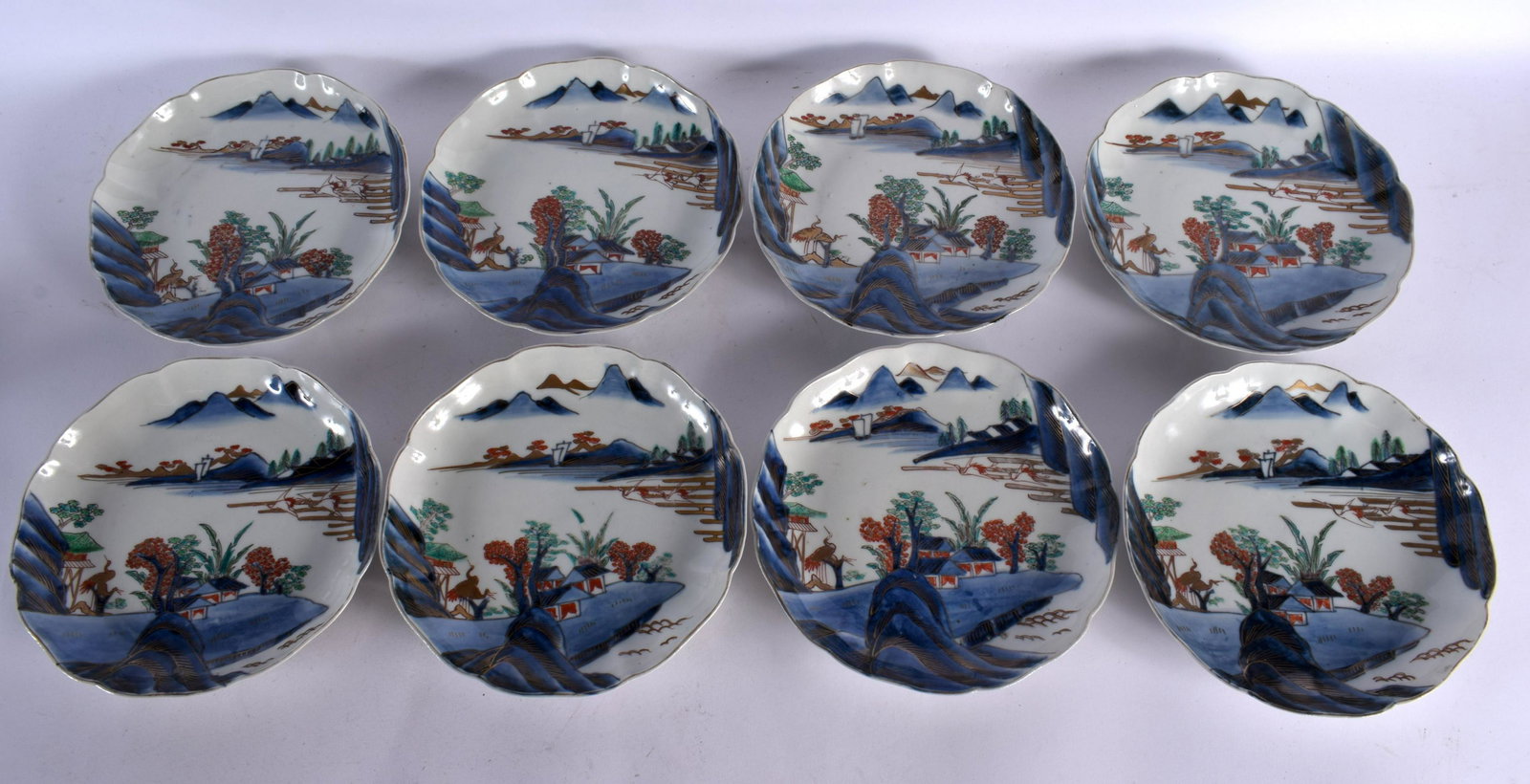 A SET OF EIGHT 19TH CENTURY JAPANESE MEIJI PERIOD IMARI LOBED PLATES painted with landscapes. 21 cm (1 of 3)