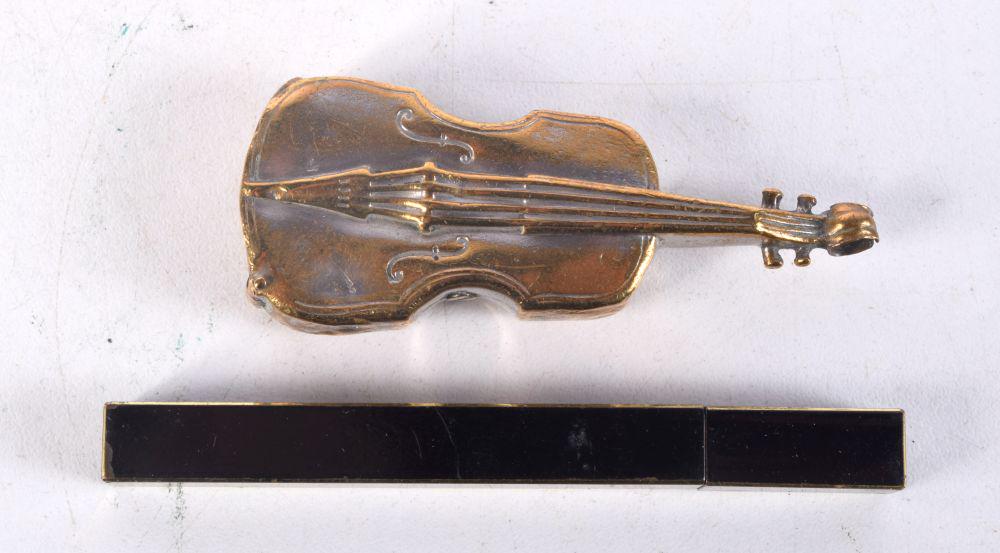 A small brass vesta case in the shape of a violin together with a small  lighter 8cm (2). (1 of 4)
