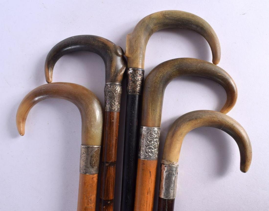 FIVE 19TH CENTURY MIDDLE EASTERN CARVED RHINOCEROS HORN WALKING CANES. 90 cm long. (5) (1 of 3)