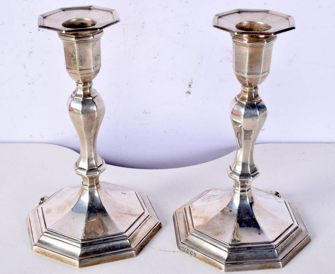 A PAIR OF SILVER WEIGHTED CANDLESTICKS. Hallmarked Sheffield 1924, 17cm x 10cm, total weight