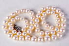 A PEARL NECKLACE WITH A 14CT GOLD CLASP. Length 51cm, pearl size 6.9mm, weight 37.1g
