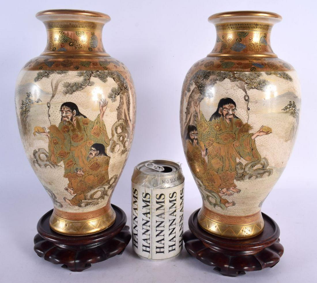 A PAIR OF 19TH CENTURY JAPANESE MEIJI PERIOD SATSUMA VASES painted with figures in landscapes. 25 cm: A PAIR OF 19TH CENTURY JAPANESE MEIJI PERIOD SATSUMA VASES painted with figures in landscapes. 25 cm high.