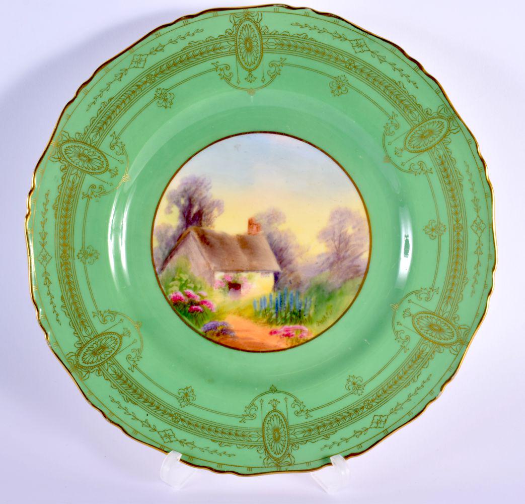 Royal Worcester plate painted with a cottage scene under a green art deco border signed by Raymond R: Royal Worcester plate painted with a cottage scene under a green art deco border signed by Raymond Rushton date code for 1933 22cm Diameter